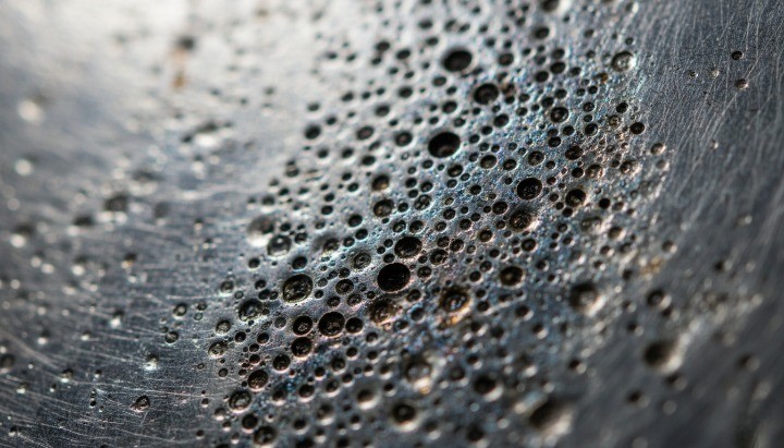 Pitting corrosion forming localized damage on stainless steel