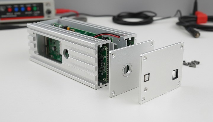 Extruded aluminum instrument housing with removable end caps and connector cutouts for test equipment.