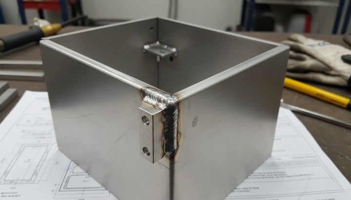 Sheet metal box U-shape enclosure with bent panels and welded corners for large electronics housings.